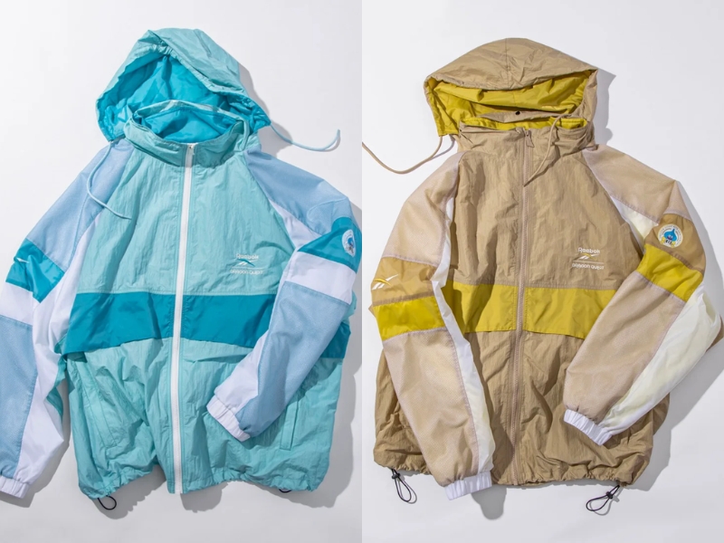 Reebok x Dragon Quest color combination track jacket light blue retro nylon with monster print on back and 40th anniversary emblem on sleeve