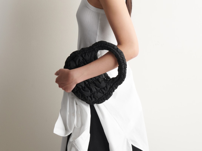 COS black micro quilted bag with 3D soft puff design and top handle