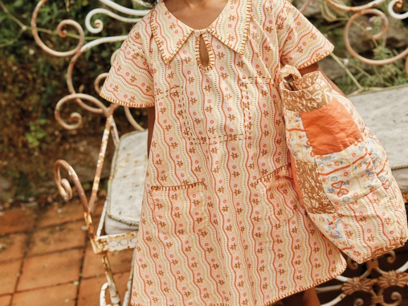 Apolina Kids Konnie Kaftan dress in a rose midsummer stripe print, featuring delicate hand-stitched details on the collar and pockets.