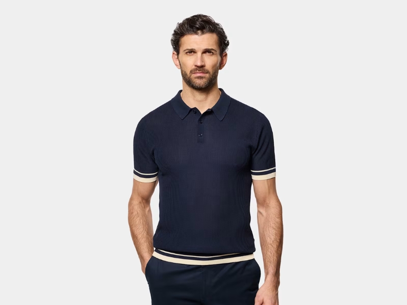 Navy blue Hawes & Curtis pure cotton polo shirt featuring contrast piping on the collar and cuffs, sold at Marks & Spencer.